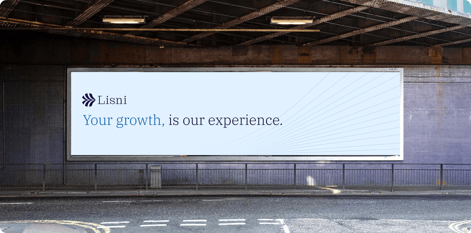 Pale blue Lisni billboard under railway bridge reading Your growth is our experience